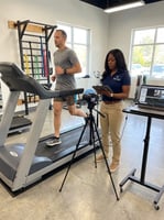 Patient working with a provider at a performance physical therapy clinic in Orlando during running gait analysis